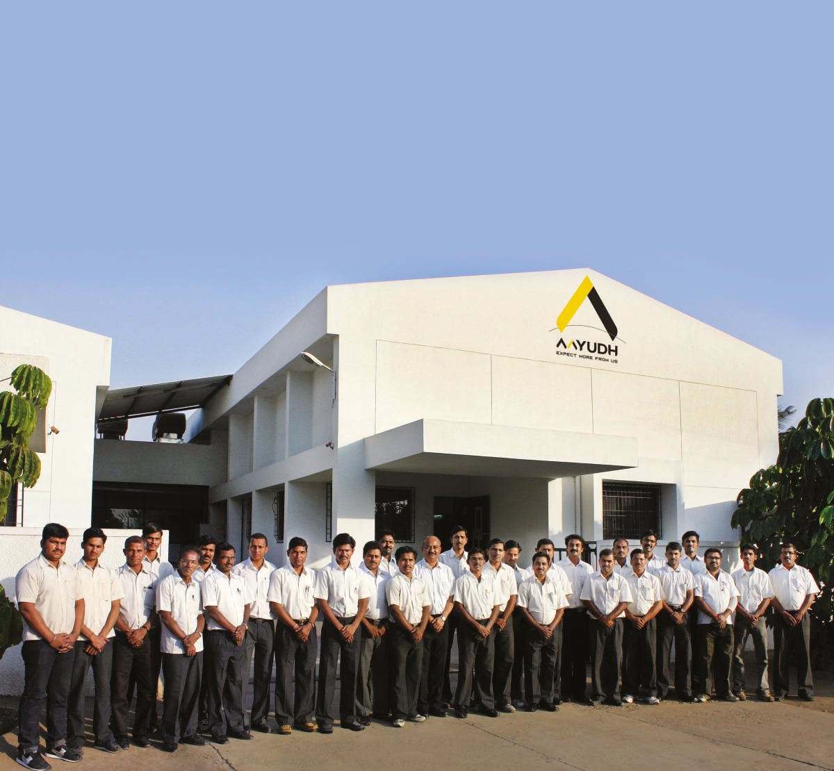 Aayudh Tools manufacturing facility with the team assembled outside the building.