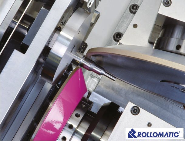 Close-up of a grinding wheel cutting a flute into a carbide blank on a Rollomatic machine.