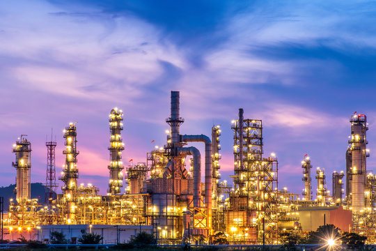 Petrochemical refinery lit at twilight, the kind of plant the components this tooling machines end up in.